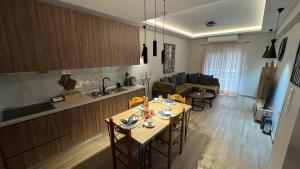 a kitchen and living room with a table and chairs at imvros home luxury in Alexandroupoli +29 photos