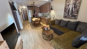 a living room with a couch and a table at imvros home luxury in Alexandroupoli