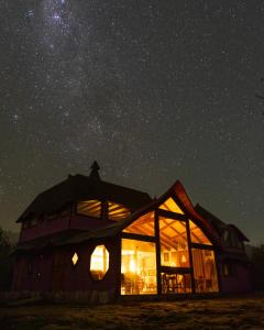a house under a starry sky at night at Spectra Lodge Boutique Hotel in Malalcahuello +49 photos