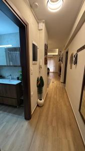 a hallway of a room with a sink and a mirror at imvros home luxury in Alexandroupoli