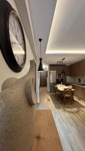 a large clock on the wall of a living room at imvros home luxury in Alexandroupoli