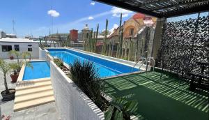 a swimming pool on the roof of a building at Hotel Siglo 17 in Oaxaca City