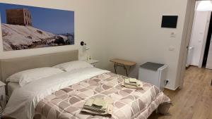 a bedroom with a bed with two towels on it at Tra Mare e Mito in Agrigento