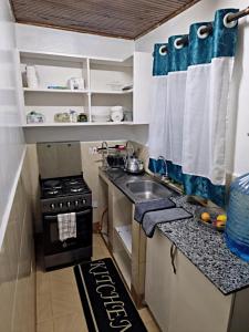 a small kitchen with a sink and a stove at Cosmic homes Ruiru Kimbo in Ruiru