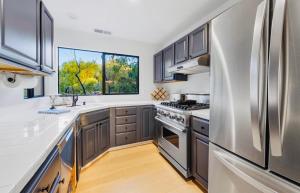 a kitchen with stainless steel appliances and a window at Charming Private Cottage in Ojai in Ojai