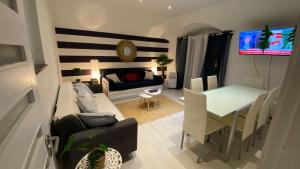 a living room with a couch and a table at Blue Beach Home with Terrace in Albufeira