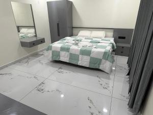 a bedroom with a bed and a mirror at Mangro villa in Mayyanād