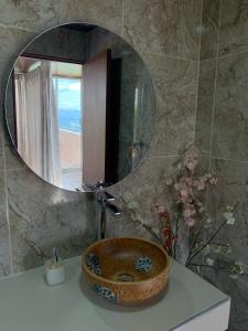 a bathroom with a sink with a mirror on it at Glamping Jalisco in Buenavista