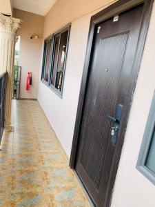 a black door on the side of a building at Water House Lodge in Apenkwa