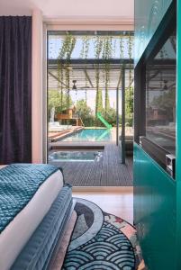 a bedroom with a view of a swimming pool at כוכב קיסר in Caesarea