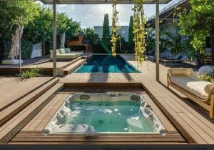 a swimming pool with a jacuzzi tub on a deck at כוכב קיסר in Caesarea
