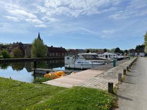 a couple of boats are docked at a dock at Le CappyToiT - Gîte climatisé in Cappy