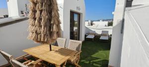 a patio with a table and chairs and a umbrella at Beautiful house with ocean views in La Cala de Mijas