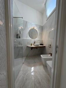 a bathroom with a shower and a toilet and a sink at Ippolita Palace LUXURY ROOMS in Otranto +36 photos