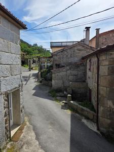 an alley with stone buildings on the side of a street at Lobios House in Bubaces +16 photos