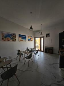 a dining room with tables and chairs in a room at B&B Kasia in Palmadula