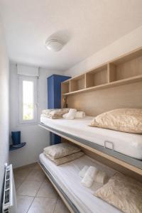 three bunk beds in a room with a window at Cap et Soleil Peaceful Private Garden, 2 Terraces, Pool, Garage, 5 Min Walk to Beach in Antibes +33 photos