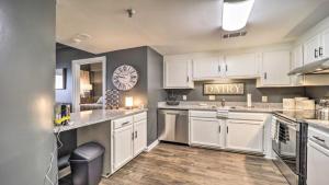 a kitchen with white cabinets and a clock on the wall at 3 Mi to Skiing Mtn-View Condo in Sugar Top Resort in Sugar Mountain