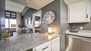 a kitchen with a large clock on the wall at 3 Mi to Skiing Mtn-View Condo in Sugar Top Resort in Sugar Mountain +18 photos
