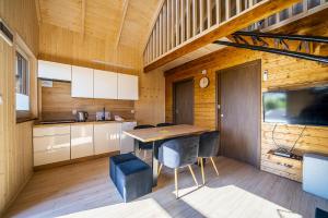 a kitchen with a table and chairs in a room at Fajne Domki in Jastarnia