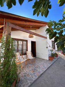 a patio with a chair and a house at Cabaña Cali in Cafayate