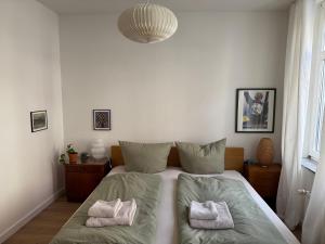 a bedroom with a bed with two pillows on it at Zum Alten Pasewalker Kaufmann Beletage in Pasewalk