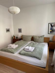 a bedroom with a large bed with two towels at Zum Alten Pasewalker Kaufmann Beletage in Pasewalk