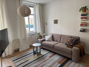 a living room with a couch and a table at Zum Alten Pasewalker Kaufmann Beletage in Pasewalk
