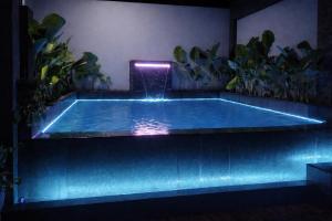 a swimming pool in a room with plants at Locale District Boutique Hotel in Quezon