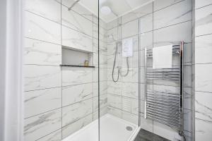 a white bathroom with a shower and a toilet at Corran House Guest House in Oban +144 photos