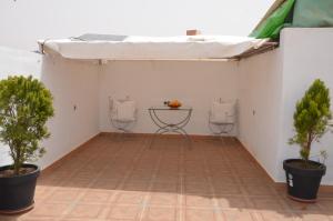 a room with two chairs and a table with trees at Residence 33 vèrte in Guelmim