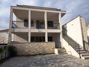 a large white building with a balcony and stairs at AiM in Kukljica
