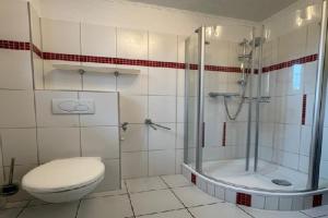 a bathroom with a shower and a toilet and a shower at Gemuetliche Doppelhaushälfte in Lubmin in Lubmin +31 photos