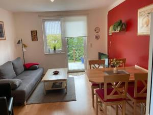 a living room with a couch and a table at Gemuetliche Doppelhaushälfte in Lubmin in Lubmin