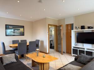 a living room with a couch and a table at Bungalow, Dornumersiel in Dornumersiel