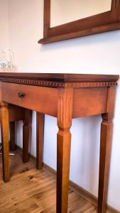 a wooden table with a mirror on a wall at Dawn Park Deluxe 3 floor in Sunny Beach