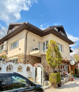 a house with a car parked in front of it at The Waterfall - Free Parking in Balchik