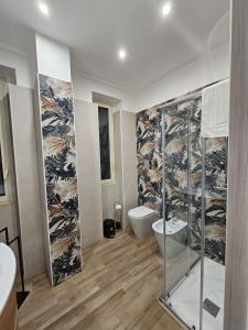 a bathroom with a glass shower and a toilet at Maison dei Mori in Messina