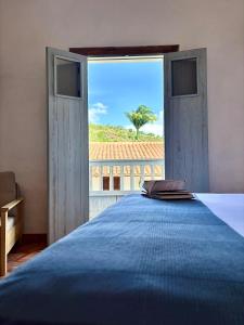 a bedroom with a large bed and a large window at Casa Mónica Barichara in Barichara