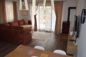 a living room with a couch and a table at Sekulic Apartman Tara in Konjska Reka