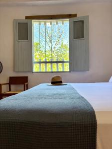 a bedroom with a bed and a window at Casa Mónica Barichara in Barichara