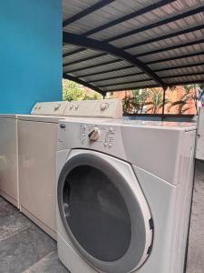 a washing machine is sitting under a roof at Casa Palma Poblado in Medellín