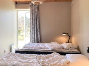 a bedroom with two beds in front of a window at 4 person holiday home in KLINTEHAMN-By Traum in Klintehamn