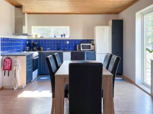 a kitchen with a table and chairs and a refrigerator at 4 person holiday home in KLINTEHAMN-By Traum in Klintehamn