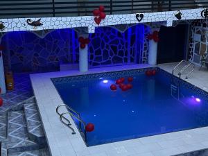 a pool with red balloons and red balls in it at Akomapa Village in Elmina +16 photos