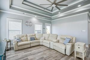 a living room with a white couch and a ceiling at Hannah Cabana home in Crystal Beach