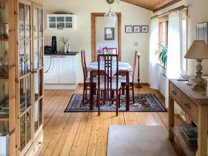 a kitchen and dining room with a table and chairs at 4 star holiday home in ELDSBERGA in Eldsberga