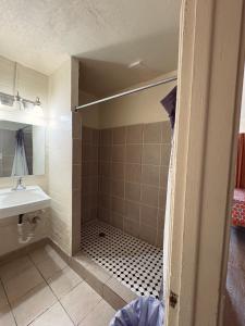 a bathroom with a shower and a sink at Border Motel in Calexico