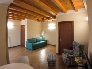 a living room with a blue couch and chairs at Casa Vacanze al Lago P1 in Monasterolo del Castello