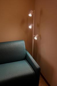 a room with a couch and two lights on the wall at Casa Vacanze al Lago P1 in Monasterolo del Castello